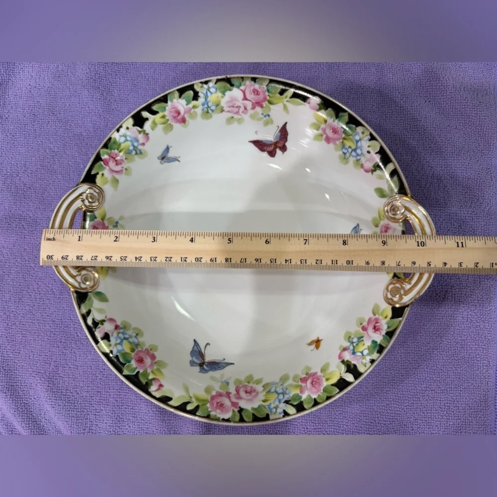 Nippon Hand-painted bowl featuring a floral motif & butterflies with gold trim